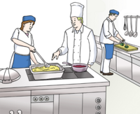 Eine große Küche in der viele Menschen in Arbeitskleidung kochen.